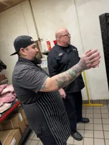 Chef Michael working with an employee at the kitchen in Centerline, Michigan
